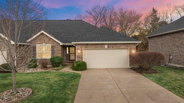 view of front of property with driveway, a garage, roof with shingles, a yard, and brick siding