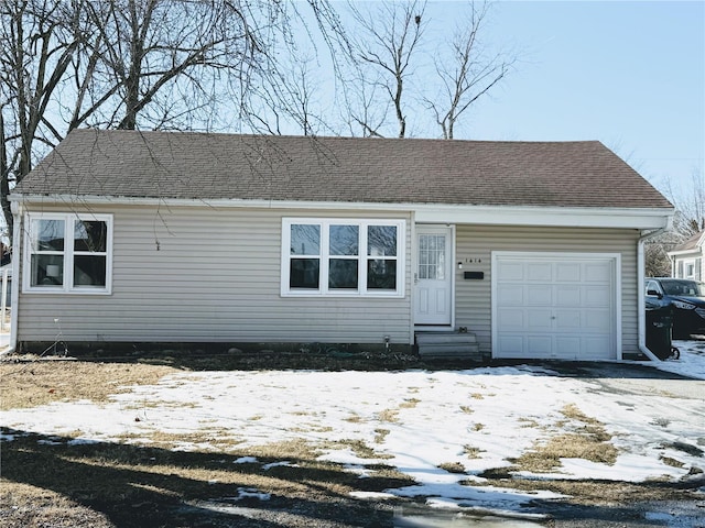 view of front of house featuring a garage, roof with shingles, and entry steps