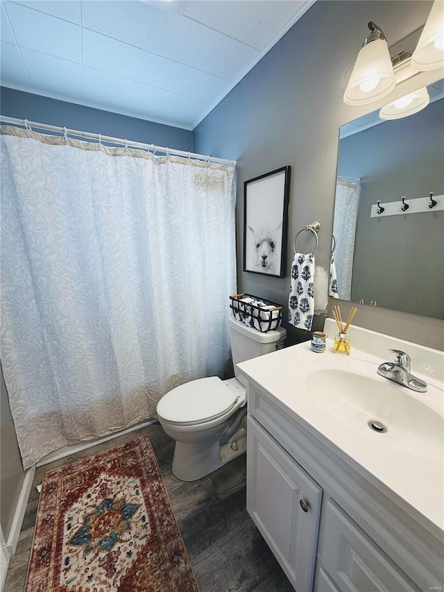 full bathroom with toilet, wood finished floors, and vanity