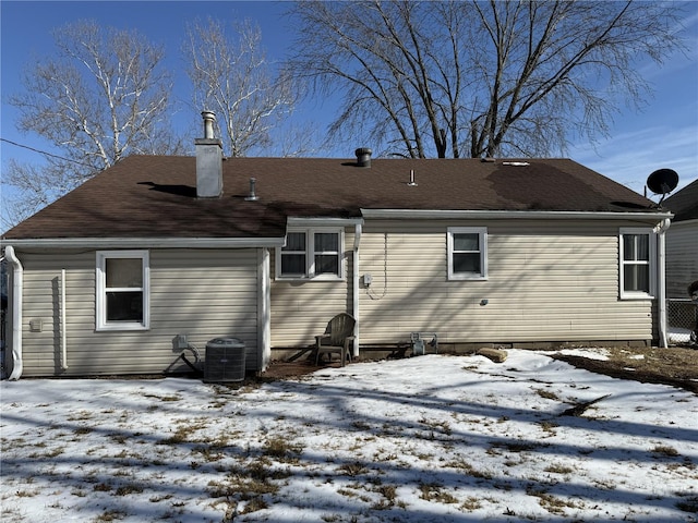 snow covered property featuring a chimney