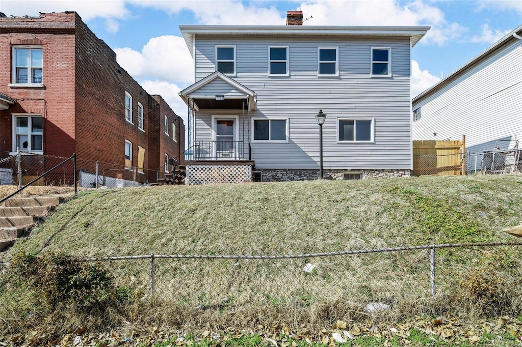 view of front of home with fence and a chimney