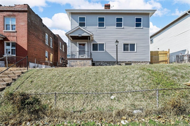 view of front of home with fence and a chimney