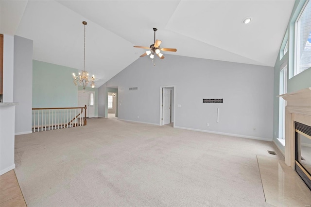 unfurnished living room featuring light carpet, baseboards, a premium fireplace, and high vaulted ceiling