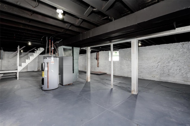 basement with electric water heater and heating unit