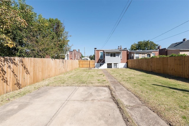 view of yard with a fenced backyard and a patio