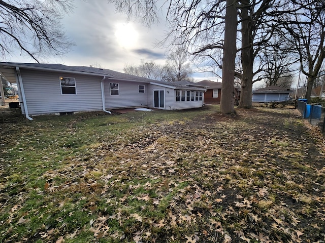 back of house with fence and a lawn