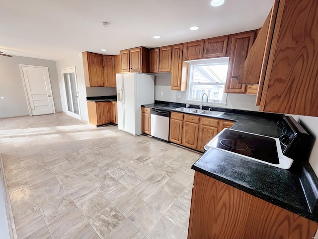 kitchen featuring white refrigerator with ice dispenser, brown cabinets, range with electric stovetop, dark countertops, and dishwasher