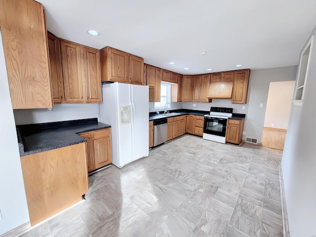 kitchen with white refrigerator with ice dispenser, a sink, electric range oven, dark countertops, and dishwasher