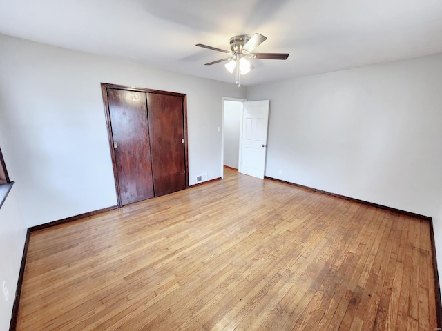 unfurnished bedroom with ceiling fan, visible vents, baseboards, a closet, and light wood-type flooring