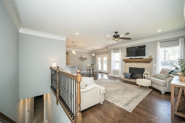 living area featuring recessed lighting, a fireplace, dark wood-type flooring, and ornamental molding