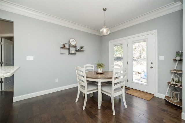 dining space with baseboards, dark wood-type flooring, and crown molding