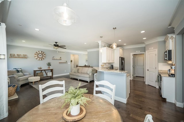 dining space with visible vents, recessed lighting, crown molding, and dark wood-style flooring