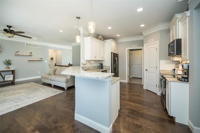 kitchen featuring light stone counters, a peninsula, stainless steel appliances, dark wood-type flooring, and open floor plan