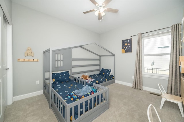 bedroom featuring baseboards, a ceiling fan, and carpet flooring