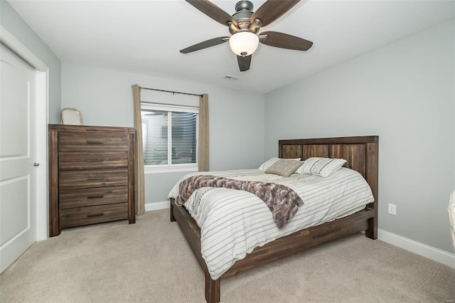 carpeted bedroom with visible vents, baseboards, and ceiling fan