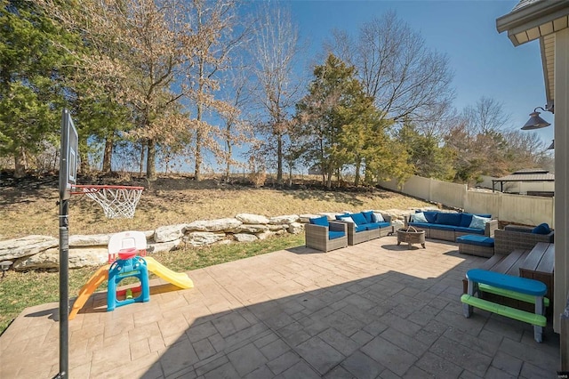 view of patio featuring an outdoor hangout area, a playground, and a fenced backyard