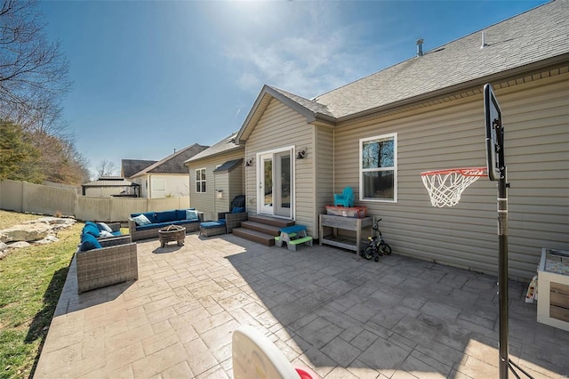 view of patio / terrace featuring fence, an outdoor living space with a fire pit, and entry steps