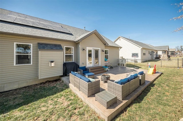 back of property with fence, solar panels, a yard, a patio area, and an outdoor hangout area