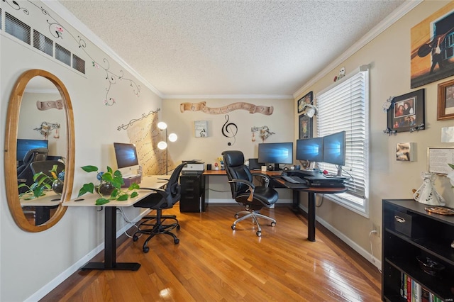 office area featuring crown molding, a textured ceiling, and wood finished floors