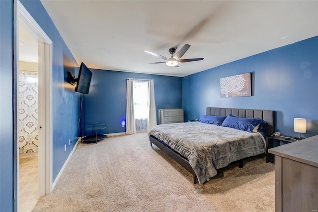 carpeted bedroom with a ceiling fan and baseboards