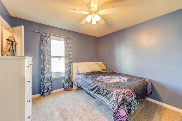 carpeted bedroom featuring ceiling fan and baseboards