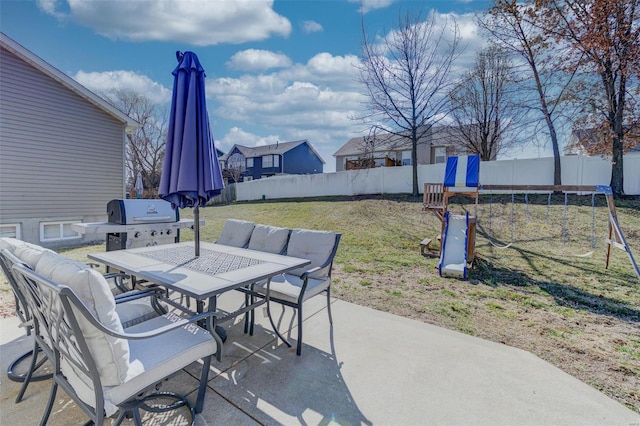 view of patio / terrace featuring a fenced backyard, a trampoline, grilling area, and outdoor dining space