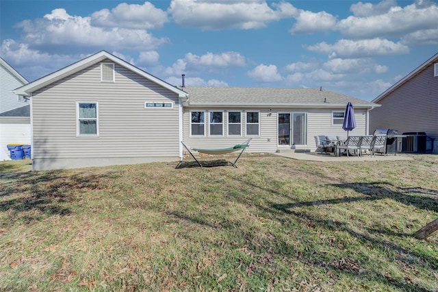 back of property featuring a yard and a patio