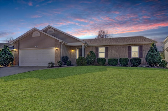 single story home with concrete driveway, brick siding, a lawn, and an attached garage