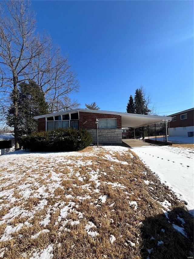 view of front of home featuring concrete driveway and an attached carport