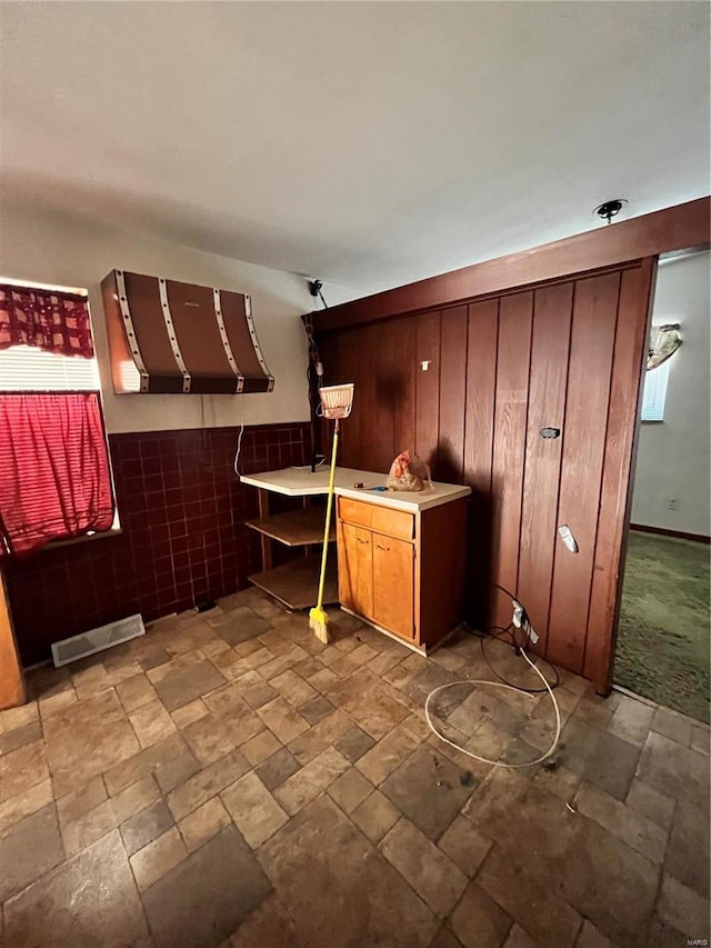 kitchen with stone finish flooring, visible vents, and light countertops