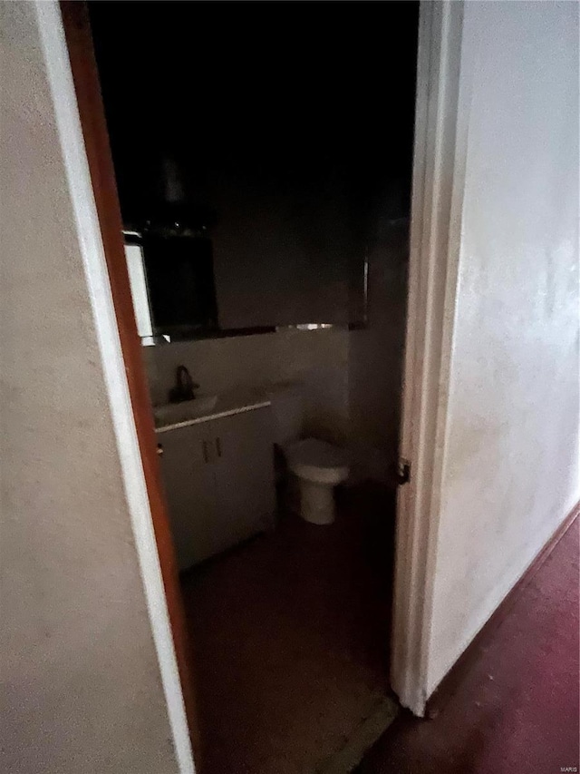 half bathroom with toilet and a sink