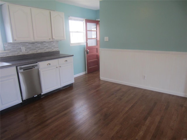 kitchen with dark wood-style flooring, dark countertops, wainscoting, white cabinets, and dishwasher