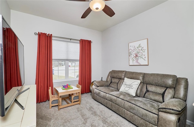 carpeted living area featuring ceiling fan