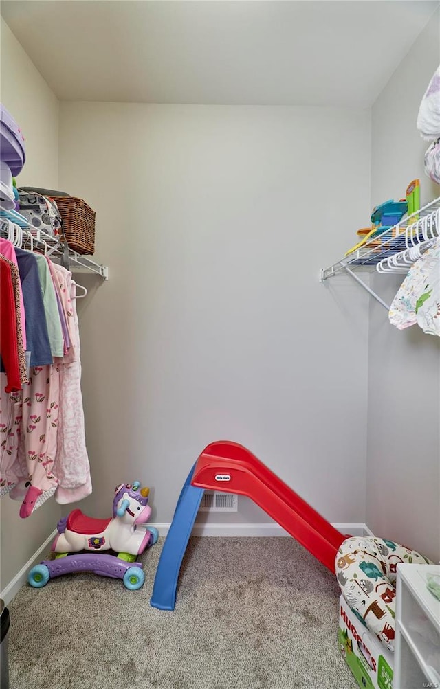 spacious closet featuring carpet flooring and visible vents