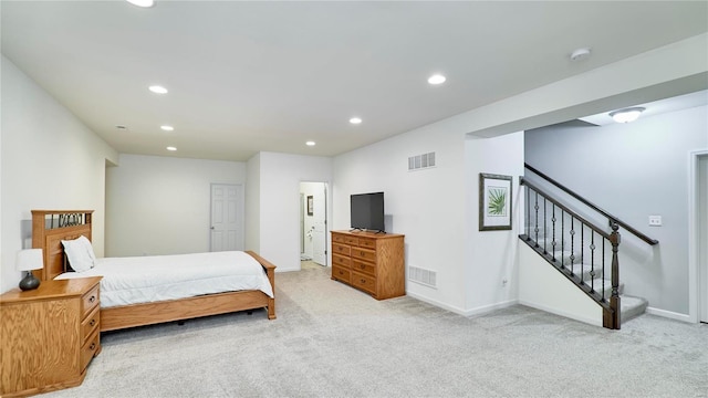 bedroom with light carpet, visible vents, and recessed lighting