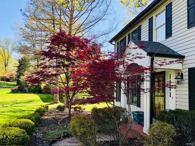 view of property exterior featuring a lawn