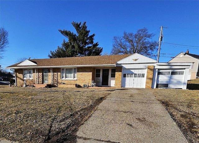 ranch-style home with driveway, a garage, and brick siding