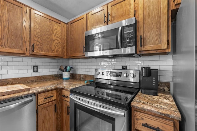 kitchen featuring tasteful backsplash, appliances with stainless steel finishes, and brown cabinets