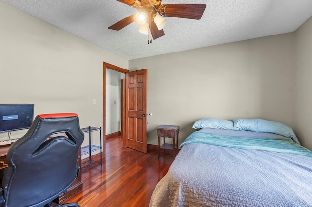 bedroom featuring a ceiling fan, a textured ceiling, baseboards, and wood finished floors