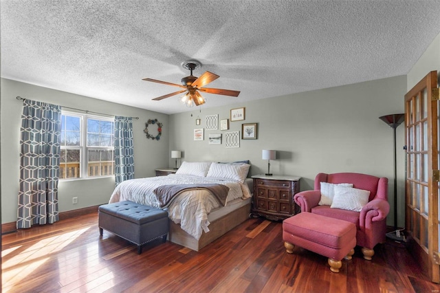 bedroom with ceiling fan, a textured ceiling, and wood finished floors