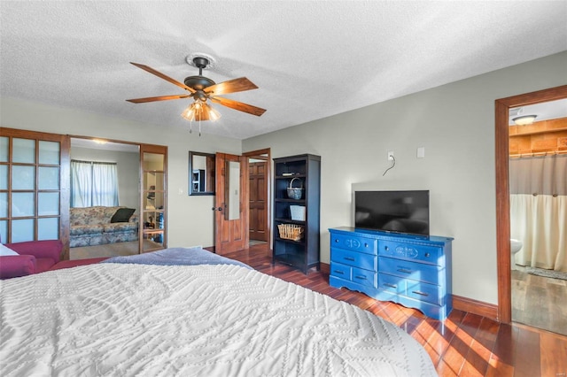 bedroom with a textured ceiling, ceiling fan, wood finished floors, and baseboards