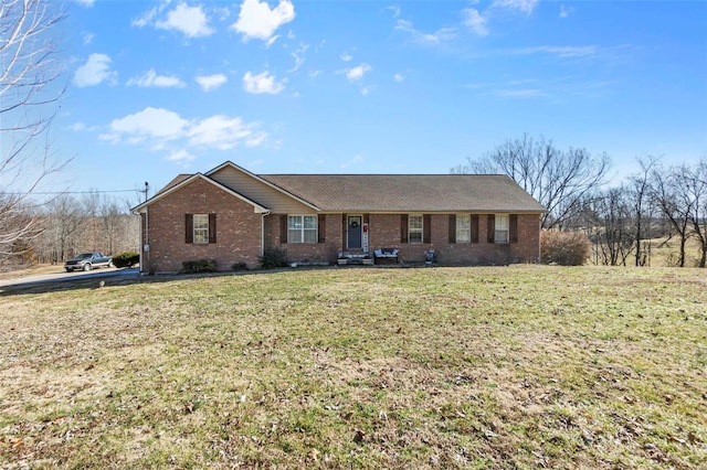 ranch-style home featuring a front yard and brick siding