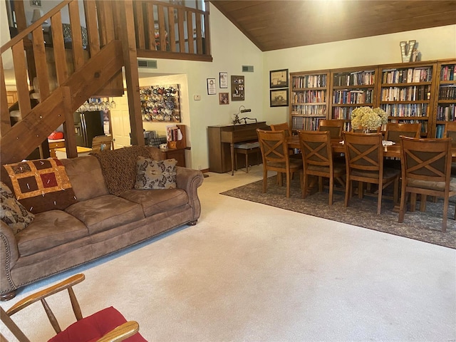 living room with carpet floors, visible vents, and high vaulted ceiling