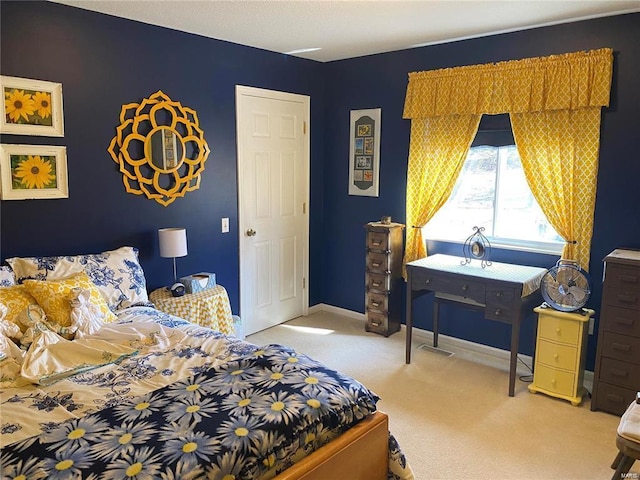 bedroom with light carpet and baseboards