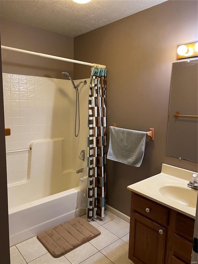 full bathroom with a textured ceiling, shower / tub combo, vanity, and tile patterned floors