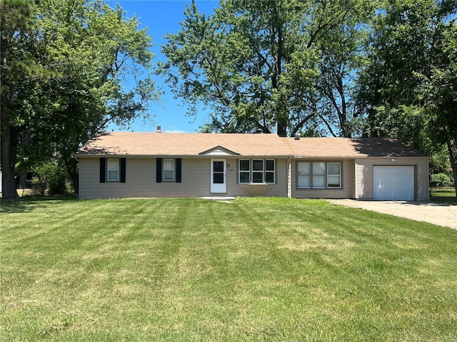 single story home featuring an attached garage, driveway, and a front lawn