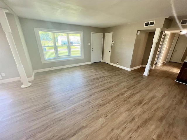 foyer entrance featuring wood finished floors, visible vents, and baseboards