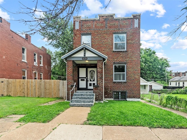 view of front of property featuring brick siding, a front yard, and fence