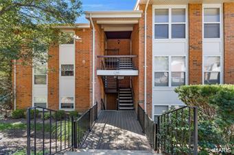 view of property with stairs and fence