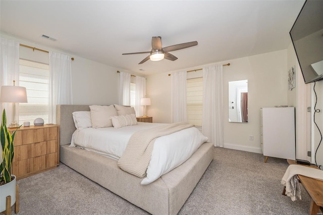 bedroom with carpet flooring, visible vents, and multiple windows